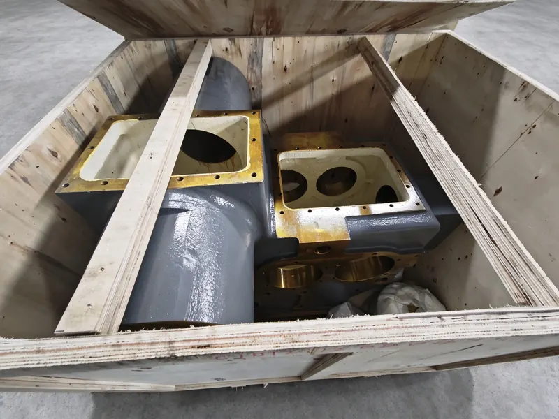 Cast housings with machined and coated faces, braced with timber inside a plywood crate.