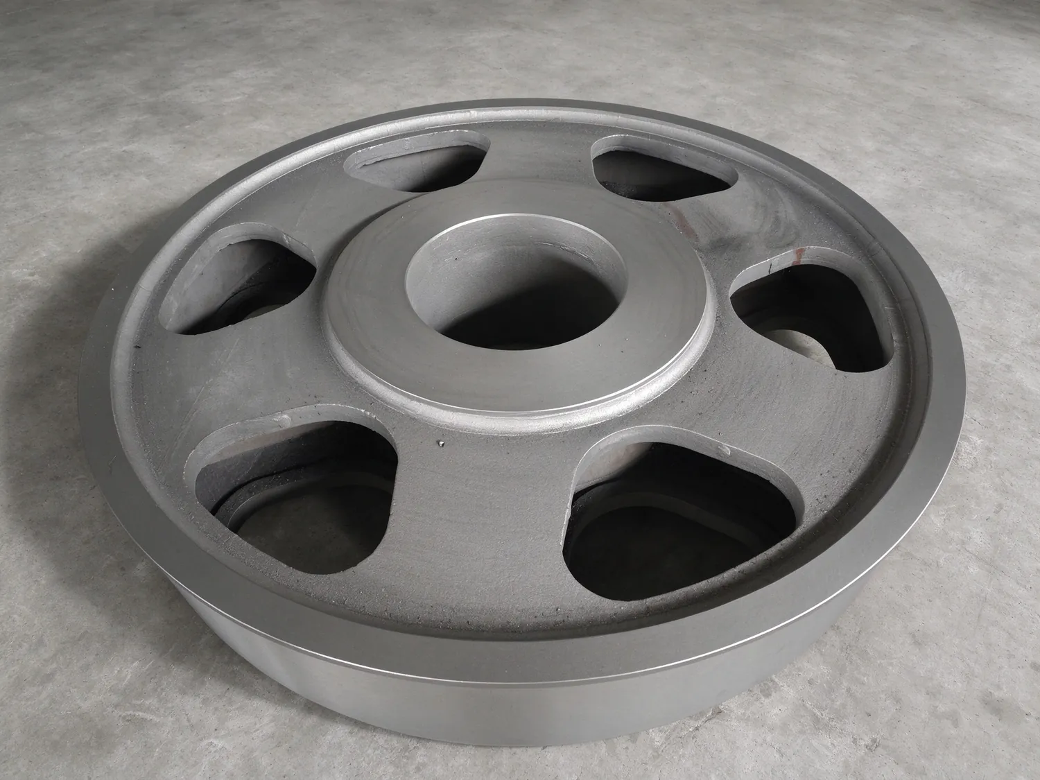 Machined cast wheel with cored openings, faces and bore finished